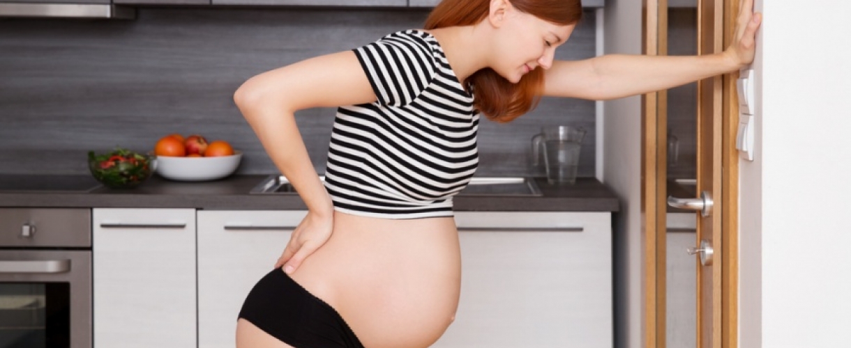 Почему болит поясница во втором триместре беременности